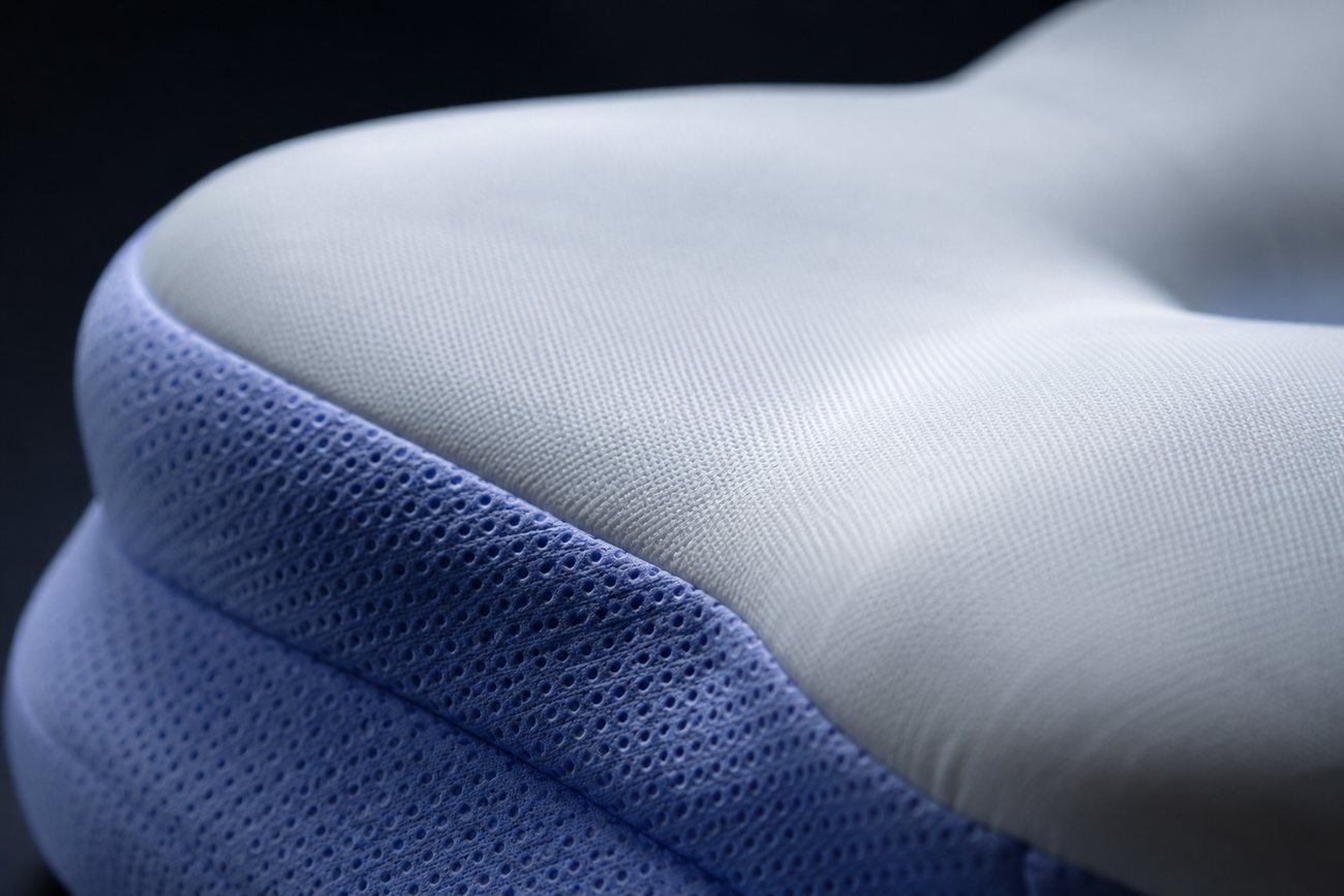 Close-up of the perforated periwinkle fabric meeting the white foam